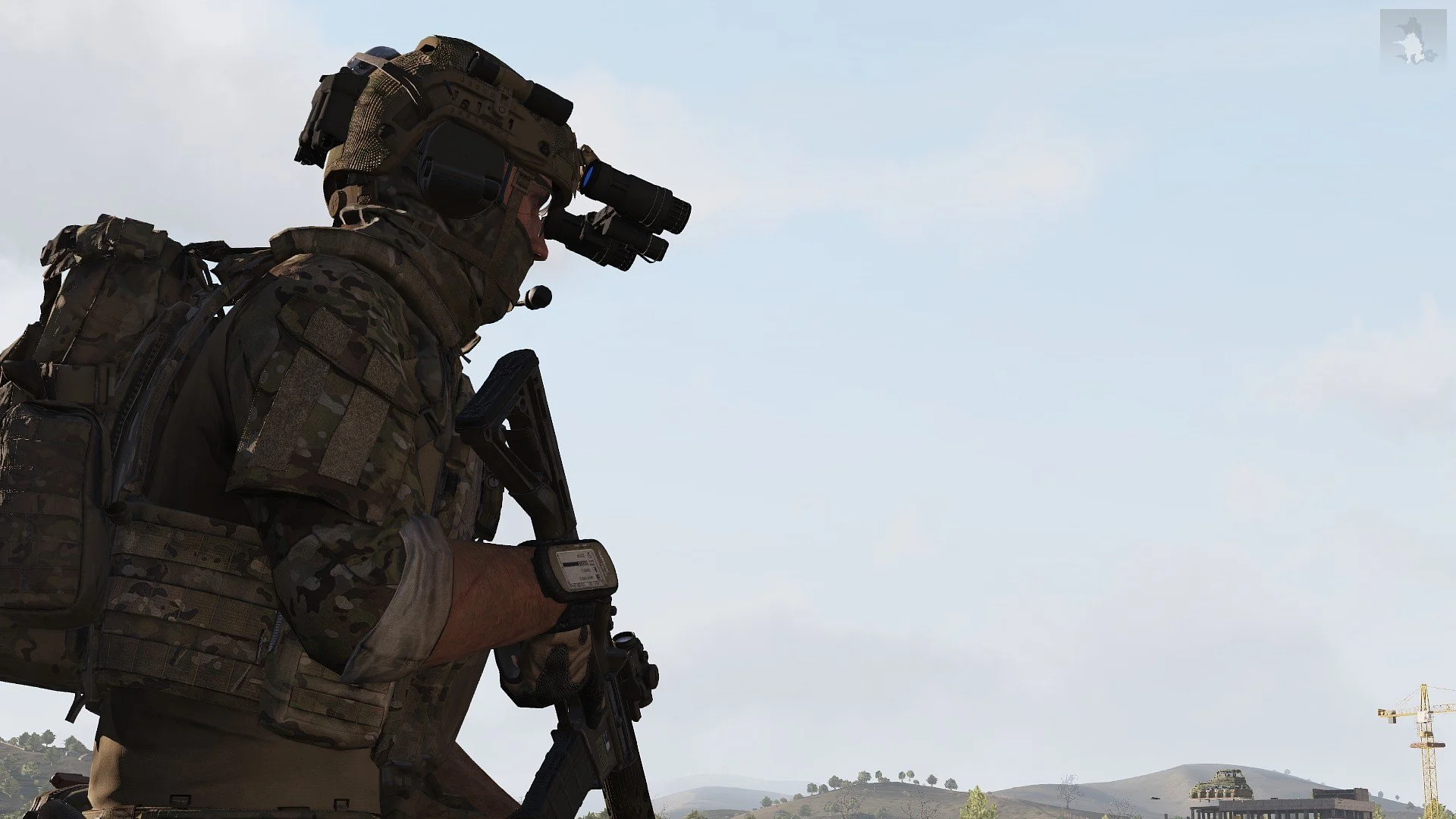Silhouette of a soldier in camouflage gear with night vision goggles, holding a rifle, outdoors with a partly cloudy sky and distant construction crane.