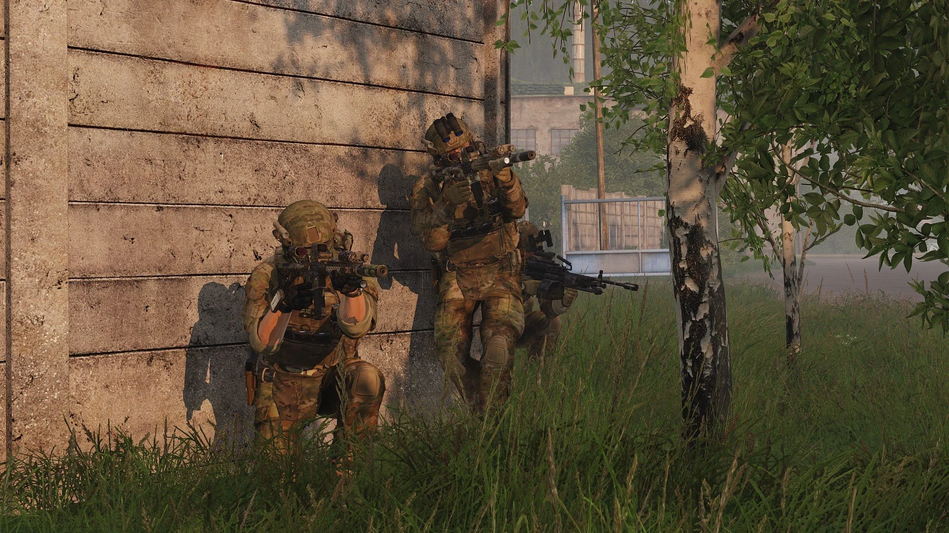 Three soldiers in camouflage gear with rifles, taking cover behind a concrete wall and trees in an outdoor setting.