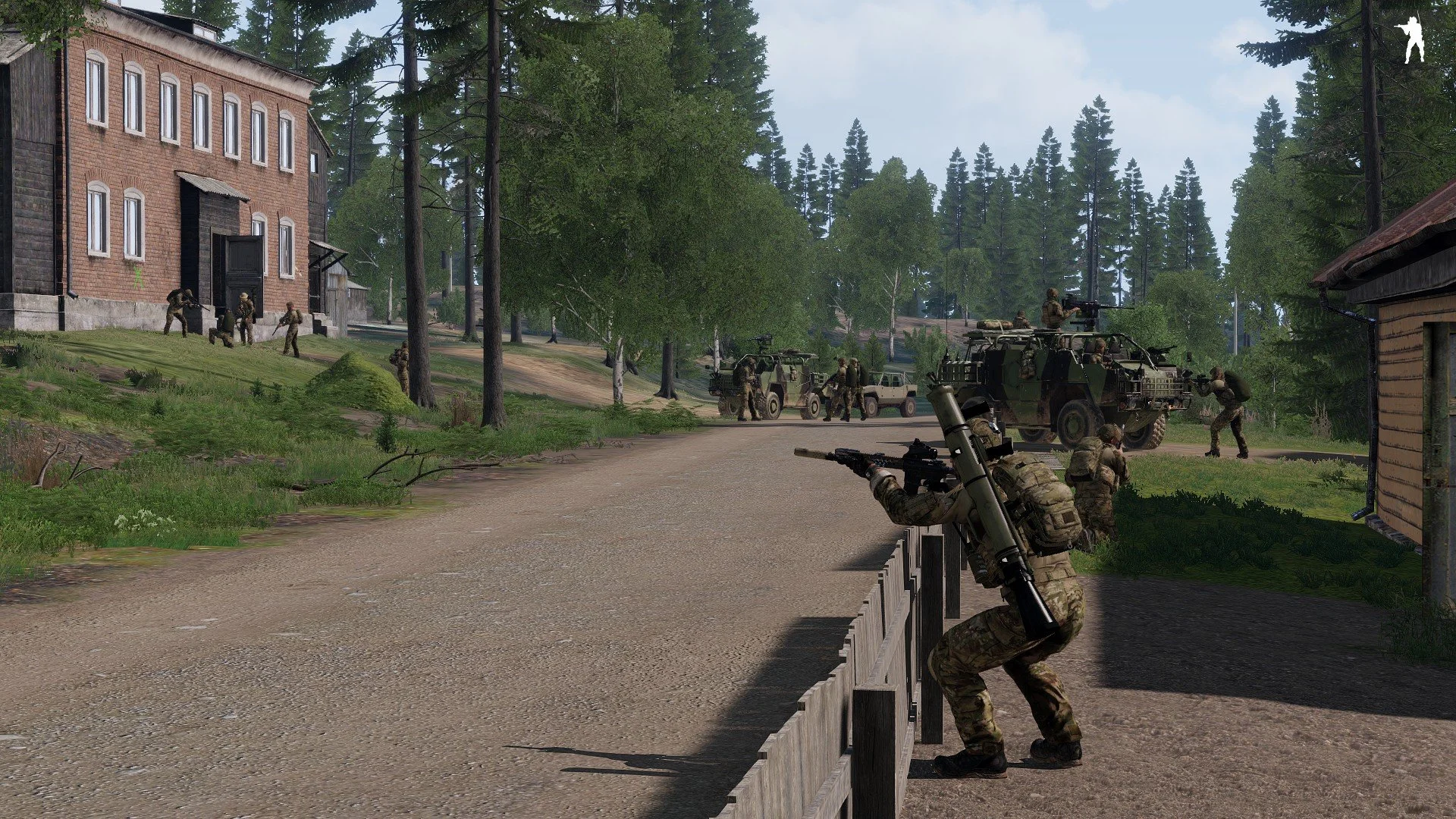 Military soldiers engaging in a tactical operation in a forested area with vehicles and a building in the background.