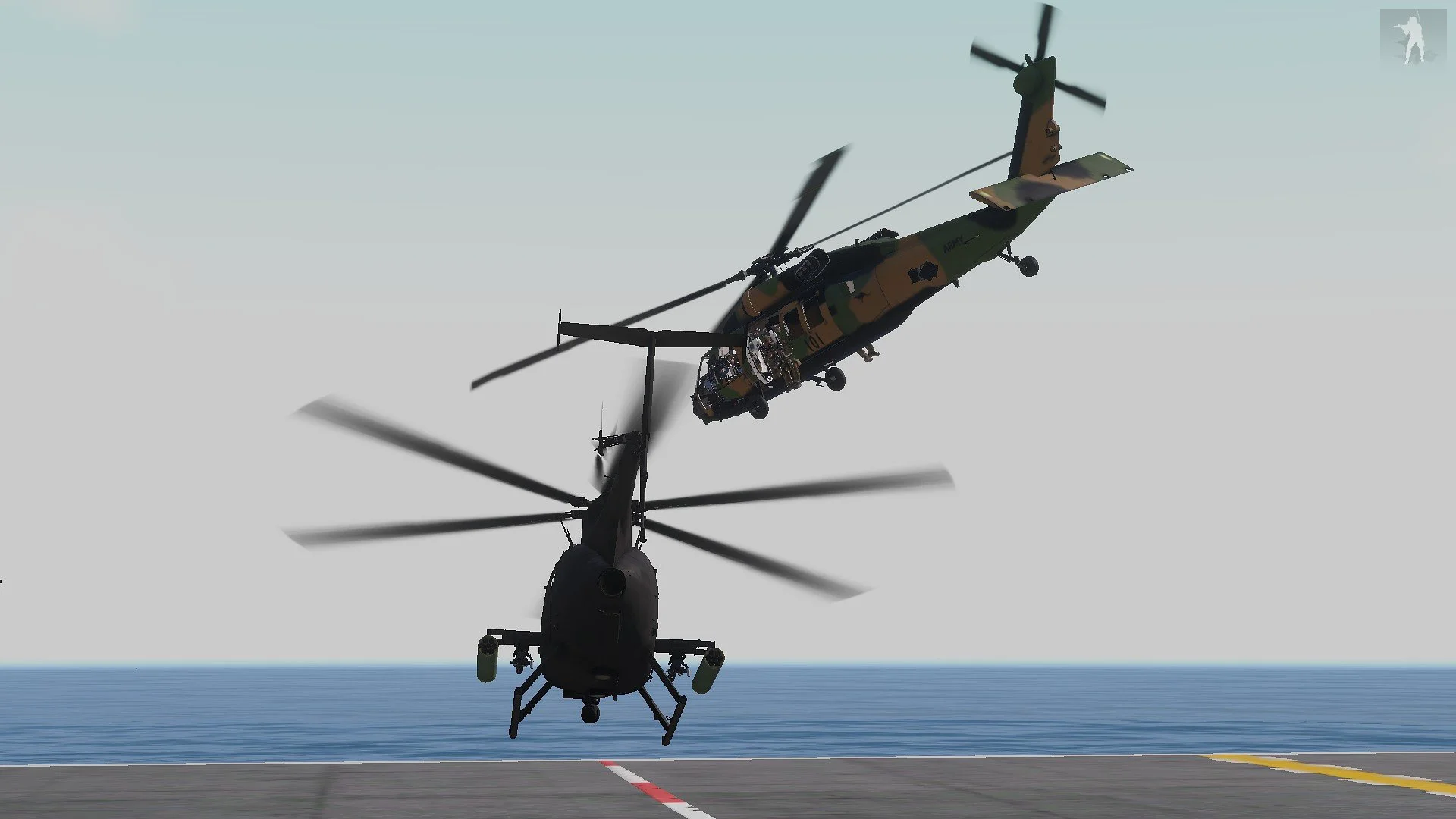 Two military helicopters in mid-air above a ship's deck with ocean in the background.