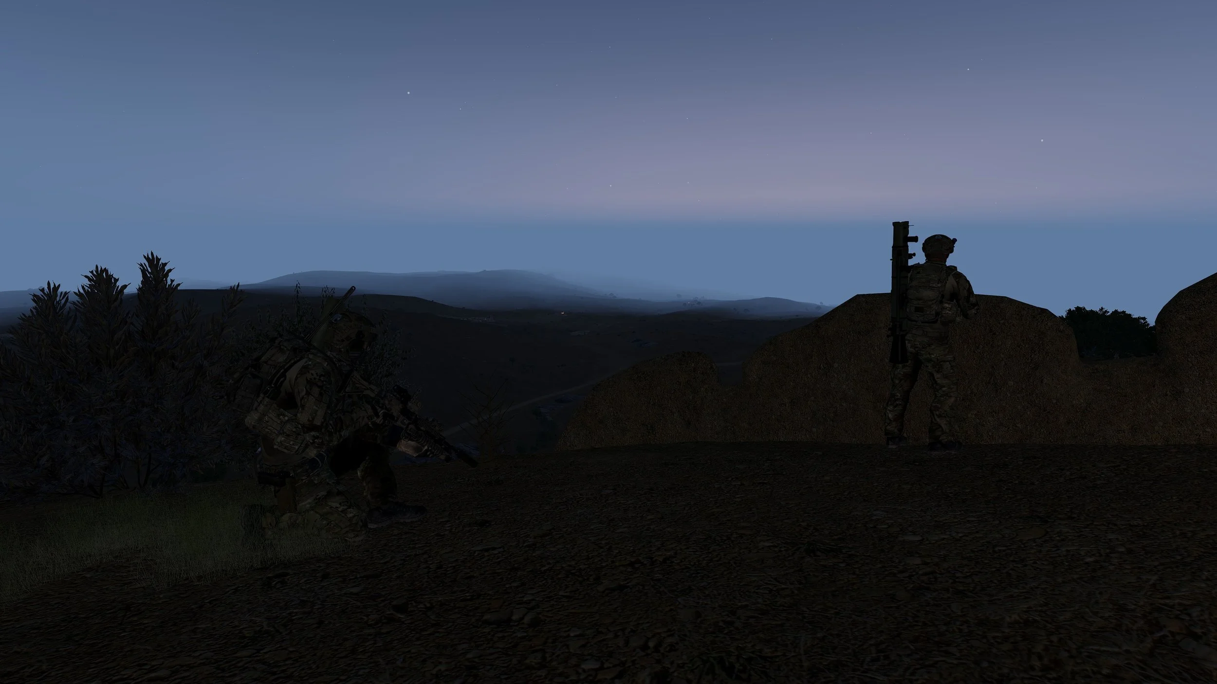 Two soldiers in camouflage gear, one kneeling with a rifle and the other standing, overlooking a landscape at dusk or dawn, with hills and mountains in the distance.