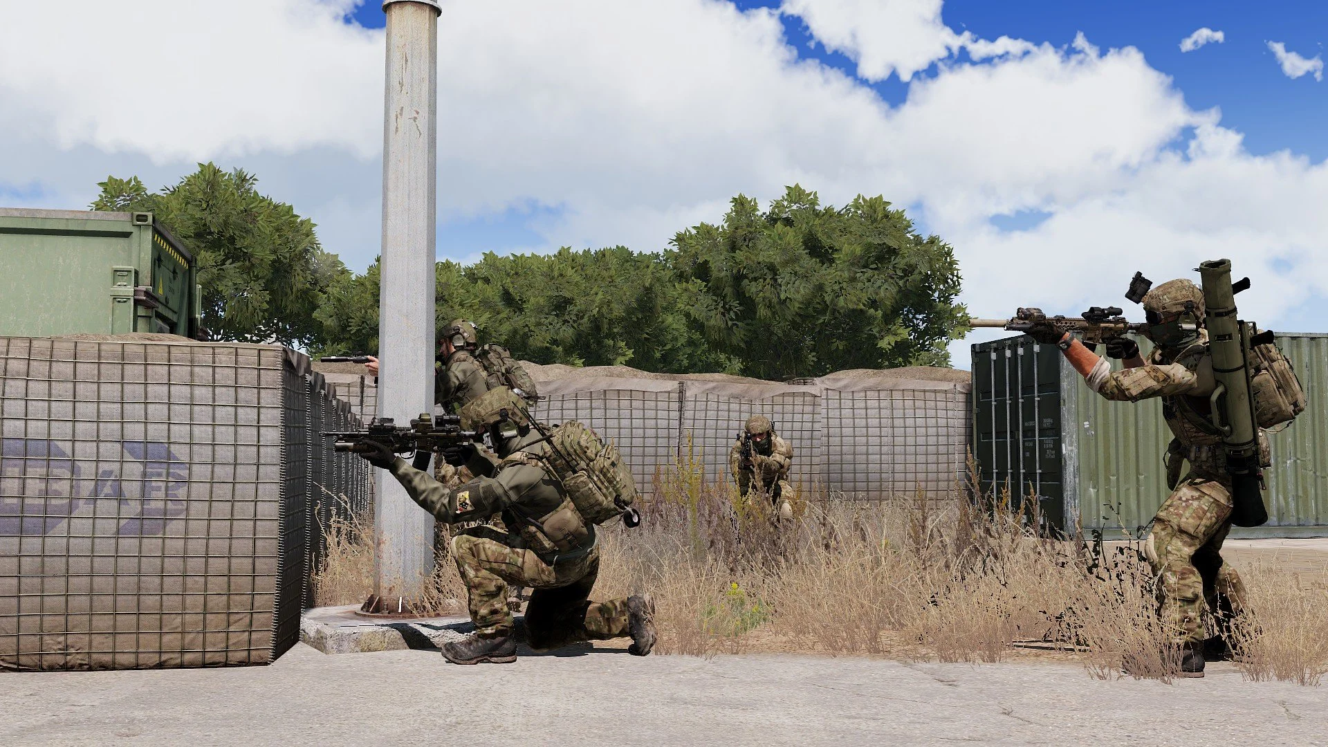 Military soldiers with rifles engaging in tactical training outdoors near containers and a fence, under a partly cloudy sky.